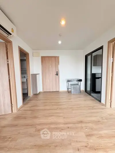 Spacious modern apartment interior with wooden flooring and open layout