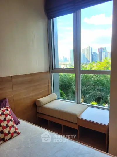 Luxurious bedroom with stunning city view and cozy window seating, perfect for relaxation and enjoying the skyline.