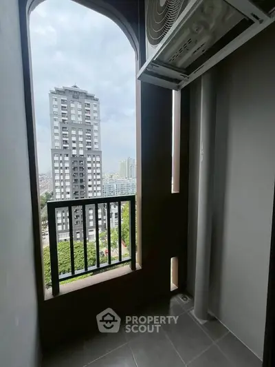 Charming balcony with cityscape view, perfect for relaxation and enjoying urban living.