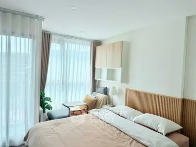 Bright and cozy bedroom with modern decor and large windows