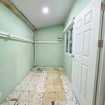 Spacious storage room with tiled floor and bright lighting, ideal for organizing household items.