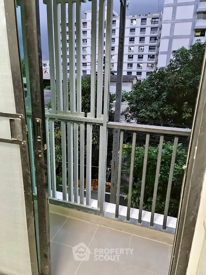 Charming balcony with urban view, perfect for relaxing and enjoying city life.
