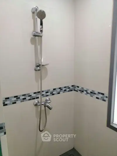 Modern bathroom shower with sleek tile design and chrome fixtures
