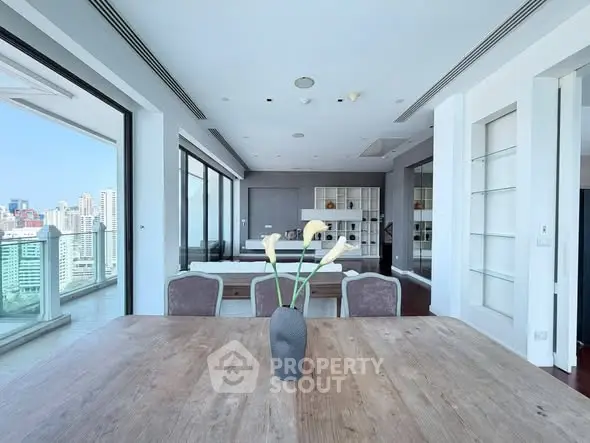 Luxurious open-plan living room with stunning city view and elegant decor