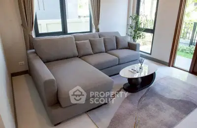 Spacious living room with modern gray sectional sofa and stylish coffee table.