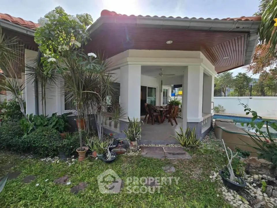 Charming villa with lush garden and poolside view, perfect for relaxation and entertaining.