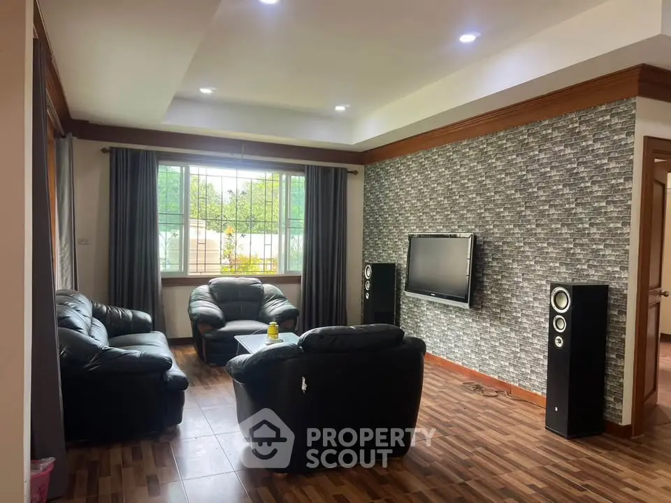 Spacious living room with modern decor and large window for natural light.