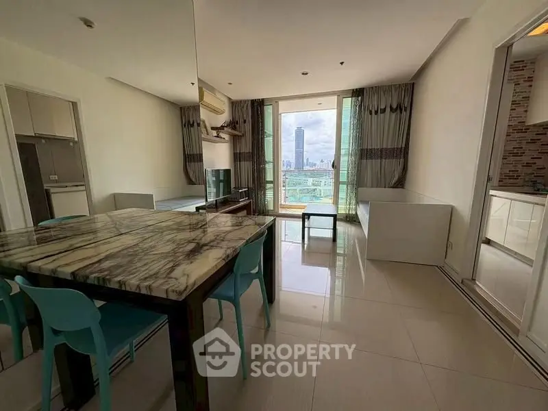 Spacious modern living room with marble dining table and city view