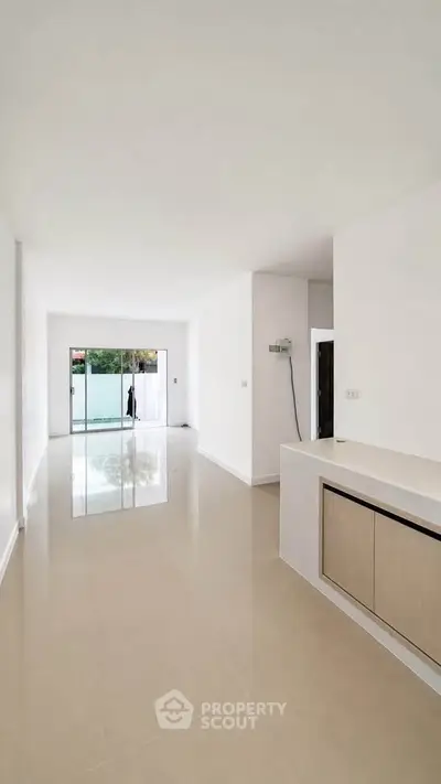 Spacious open-plan living area with sleek modern design and large windows for natural light.