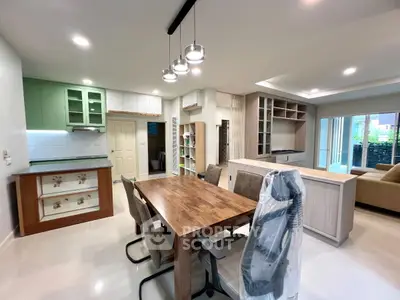 Modern open-plan living and dining area with stylish furniture and ample natural light.
