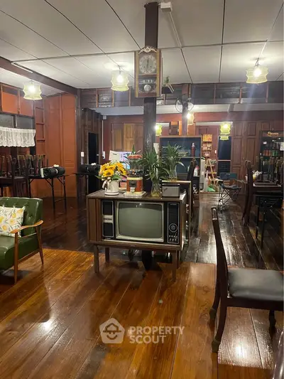 Charming vintage living room with retro TV and wooden decor, perfect blend of nostalgia and comfort.