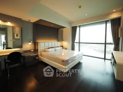 Luxurious bedroom with stunning floor-to-ceiling windows and elegant dark wood flooring.