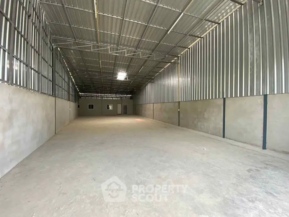 Spacious industrial warehouse with high ceilings and metal walls for versatile storage solutions.