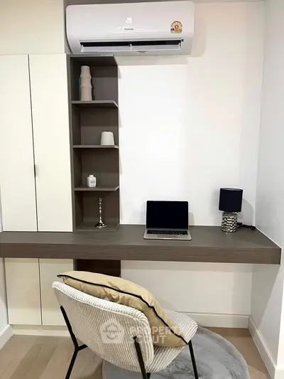 Modern study area with sleek desk, laptop, and air conditioning unit.