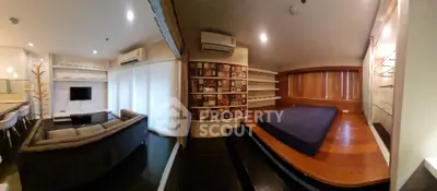 Modern living room with unique wooden platform bed and sleek shelving