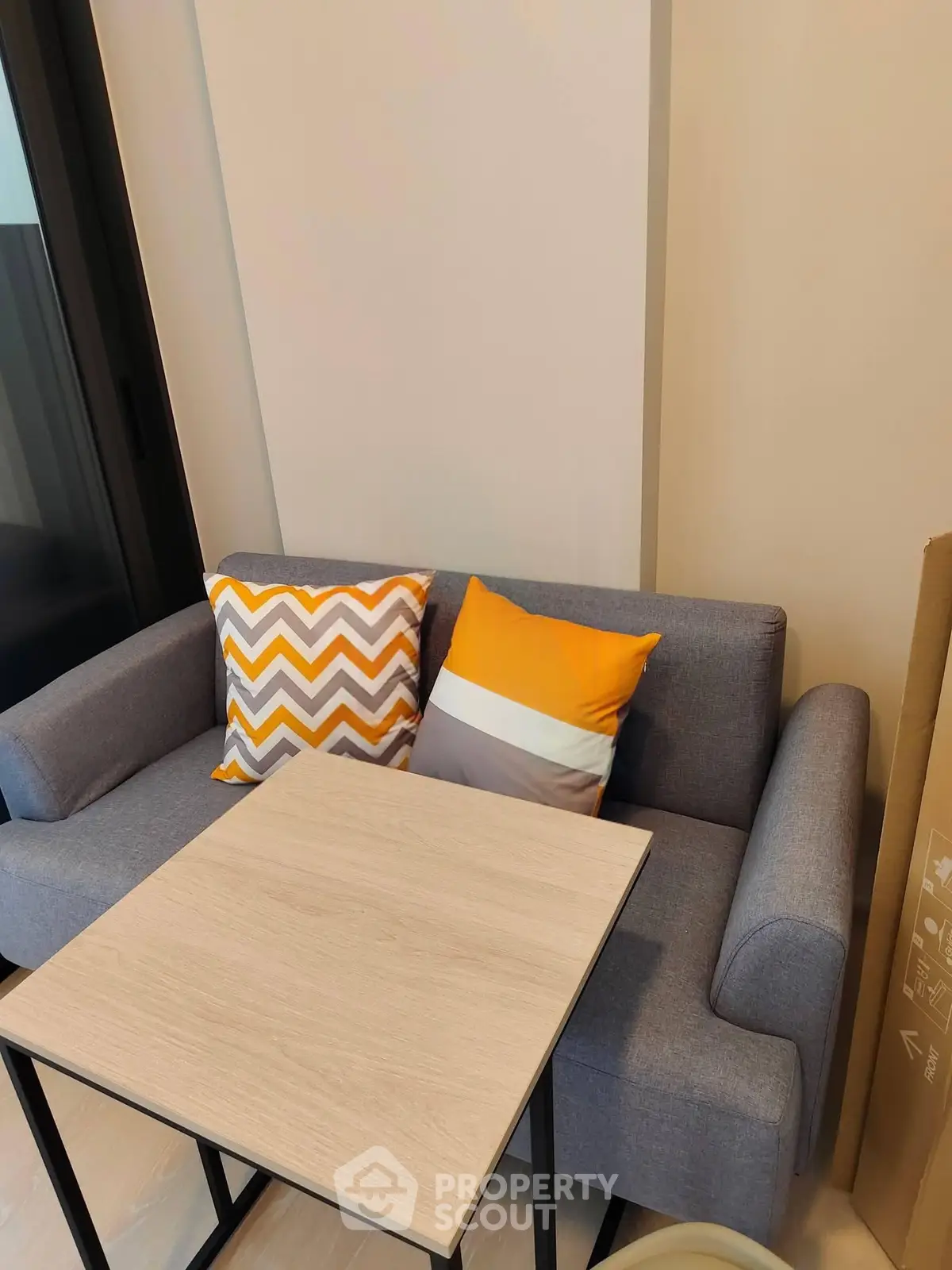 Cozy living room with modern sofa and stylish cushions, perfect for relaxation and comfort.