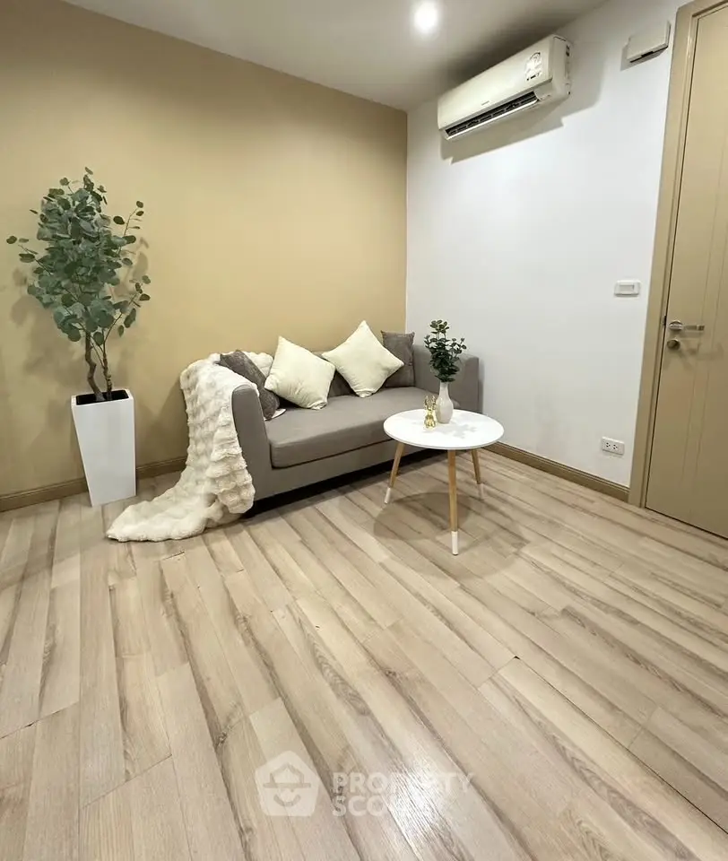 Modern living room with stylish sofa, air conditioning, and elegant decor in a cozy apartment.