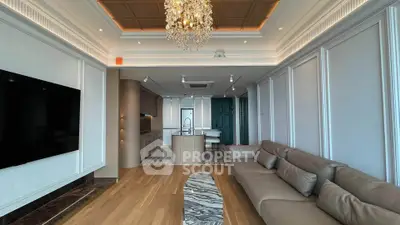 Luxurious living room with elegant chandelier and modern open kitchen layout