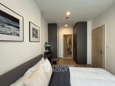 Modern bedroom with stylish decor and ensuite bathroom in a contemporary apartment.