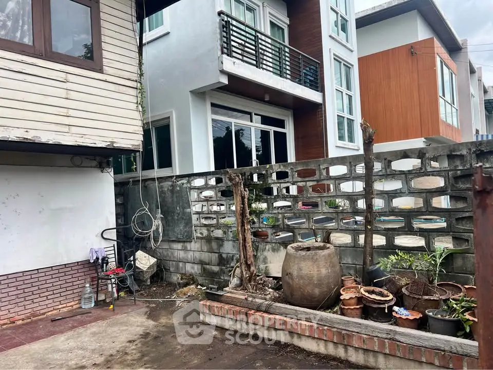 Charming urban exterior with potential for renovation, featuring a spacious patio and modern building facade.
