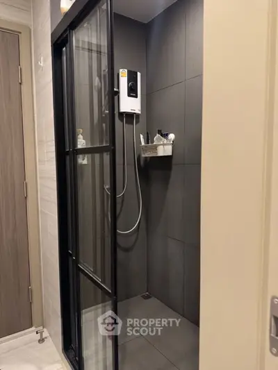 Modern bathroom with sleek shower enclosure and contemporary fixtures.