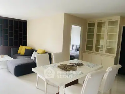 Elegant living room with modern furniture and dining area, perfect for stylish urban living.