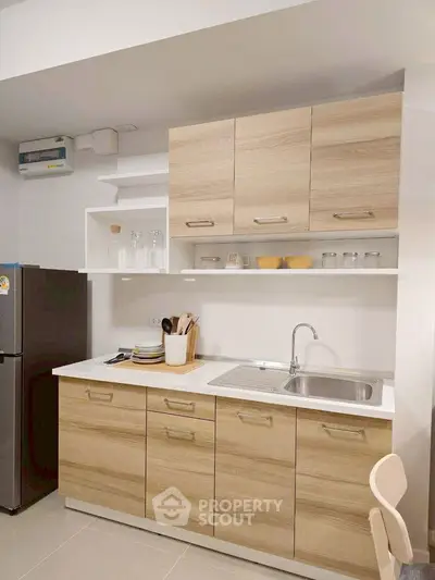 Modern kitchen with wooden cabinets and stainless steel sink
