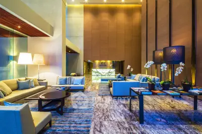 Luxurious modern lobby with elegant seating and ambient lighting in a high-end residential building.