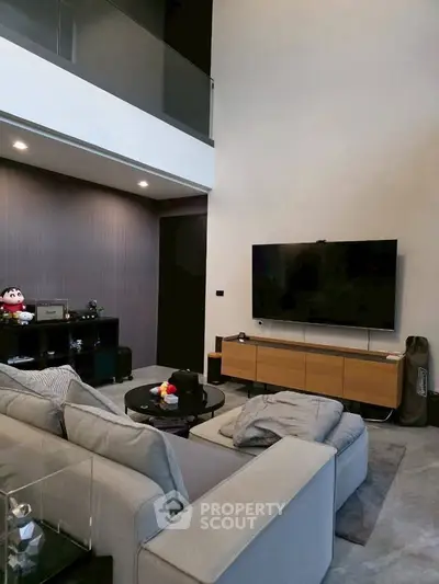 Modern living room with high ceiling and sleek furniture design