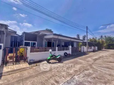Charming suburban house with driveway and motorbike, perfect for family living.