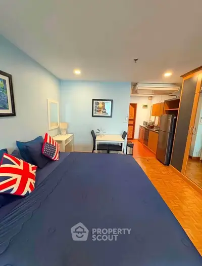 Cozy studio apartment with modern kitchen and stylish decor, perfect for urban living.