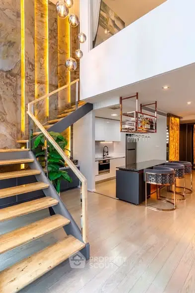Luxurious modern kitchen with open layout and stylish staircase