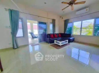 Spacious living room with modern furniture and large windows offering natural light.