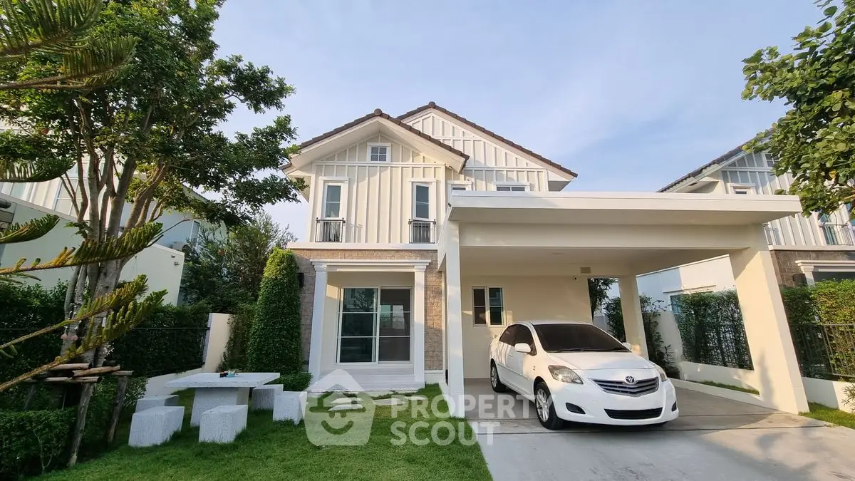 Charming two-story house with carport and lush green garden