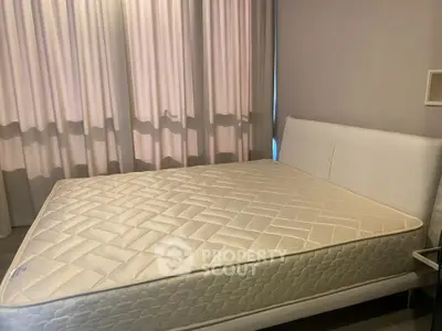Spacious bedroom with elegant bed and soft lighting, perfect for relaxation and comfort.