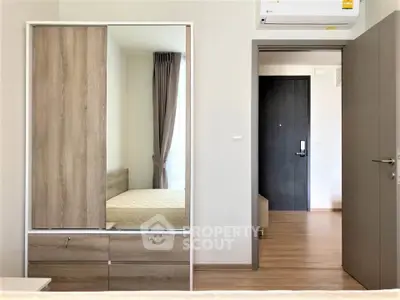 Modern bedroom with wooden wardrobe and air conditioning in a stylish apartment.