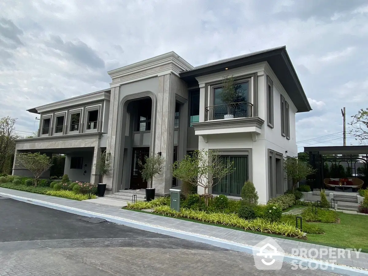 Luxurious modern villa with elegant architectural design, featuring a grand entrance, lush landscaping, and a serene environment, perfect for upscale living.