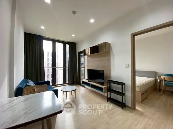 Modern living room with balcony access and stylish furniture
