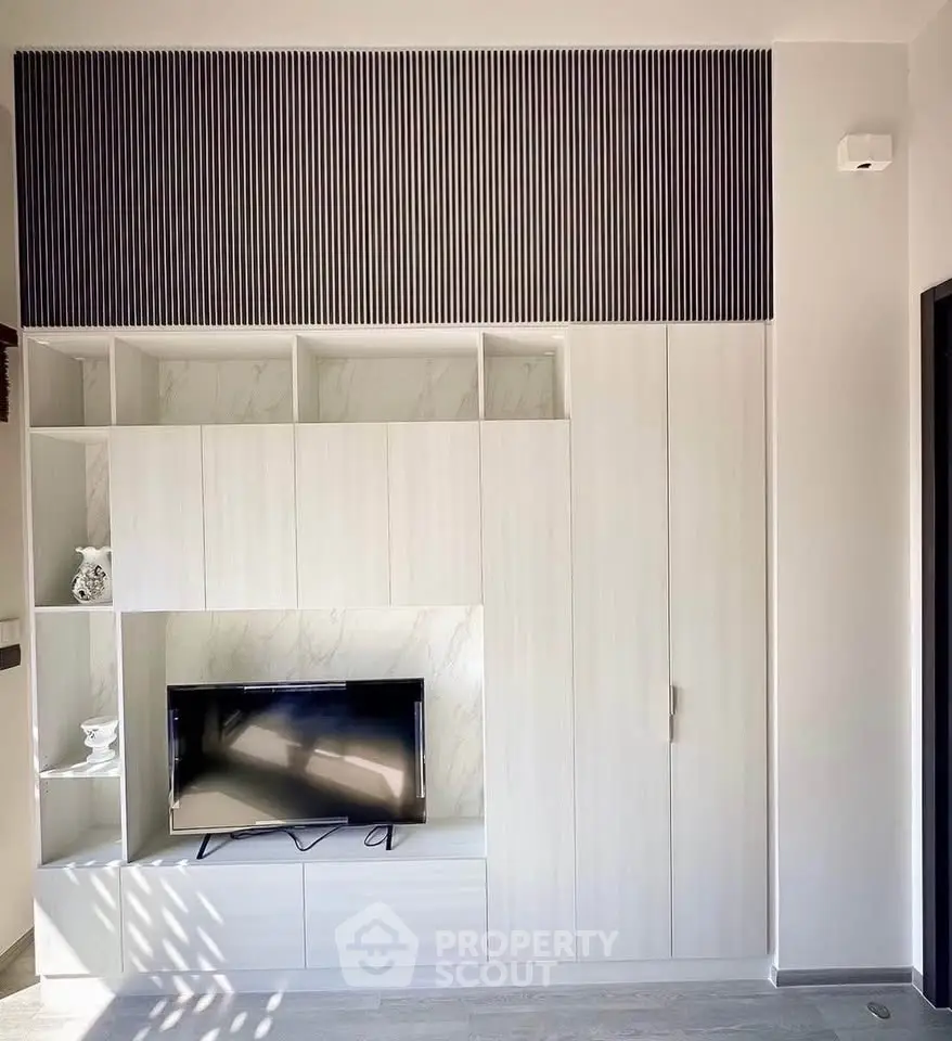 Modern living room with sleek built-in entertainment unit and stylish decor