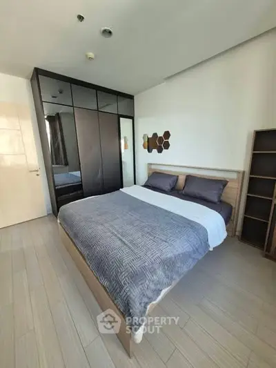 Modern bedroom with stylish decor and ample storage space