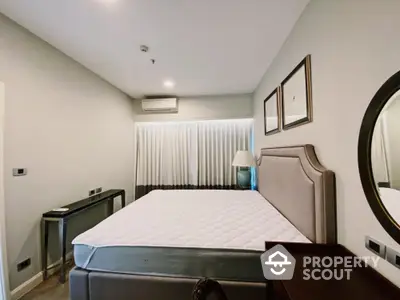 Modern bedroom with stylish decor and comfortable bed in a cozy apartment.