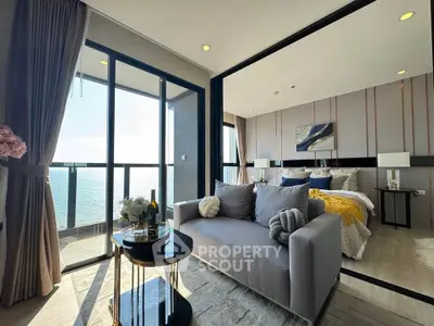 Luxurious ocean-view living room with modern decor and cozy seating area.