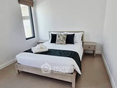 Cozy minimalist bedroom with natural light and modern decor