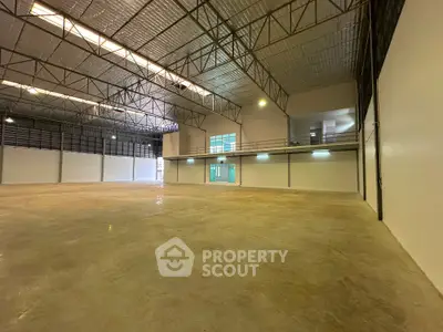 Spacious industrial warehouse with high ceilings and ample natural light