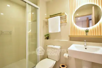 Modern bathroom with sleek shower and elegant lighting