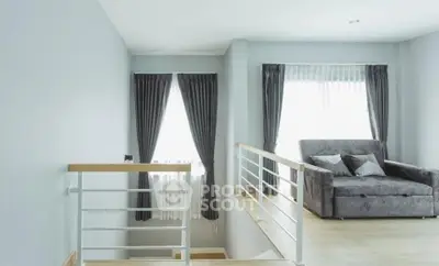 Modern living room with stylish gray sofa and elegant curtains