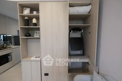 Modern apartment interior with stylish storage solutions and sleek kitchen design.