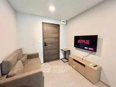 Cozy living room with modern TV setup and comfortable sofa