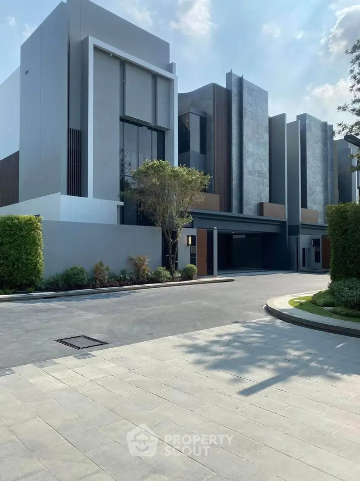 Modern architectural building exterior with sleek design and lush landscaping.