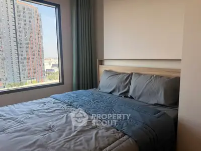 Modern bedroom with city view and stylish bedding